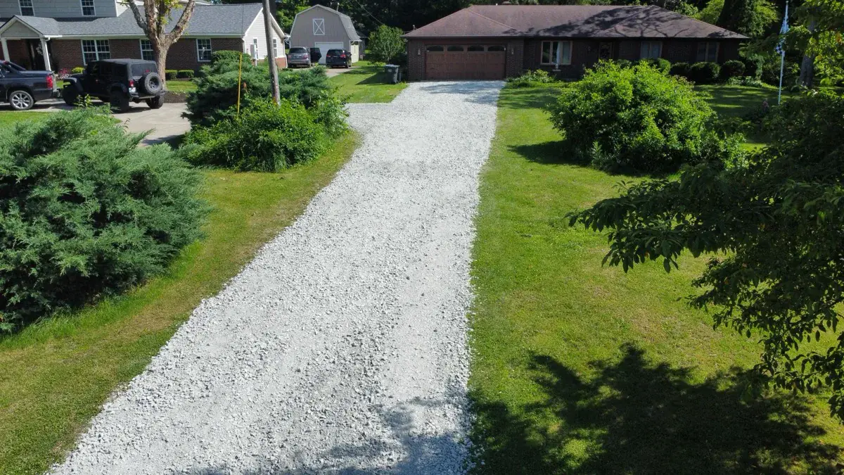 A driveway covered edge to edge in fresh white gravel