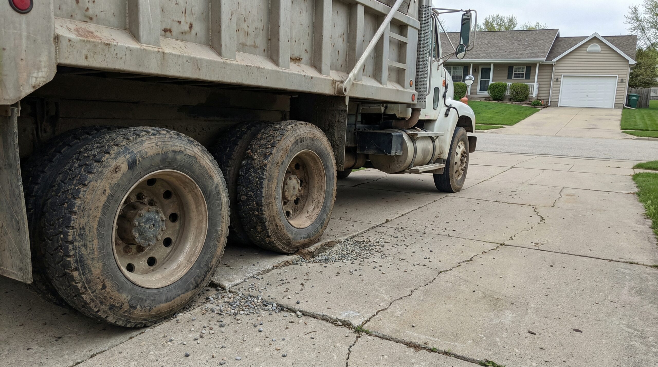 Dump truck on residential driveway showing weight distribution