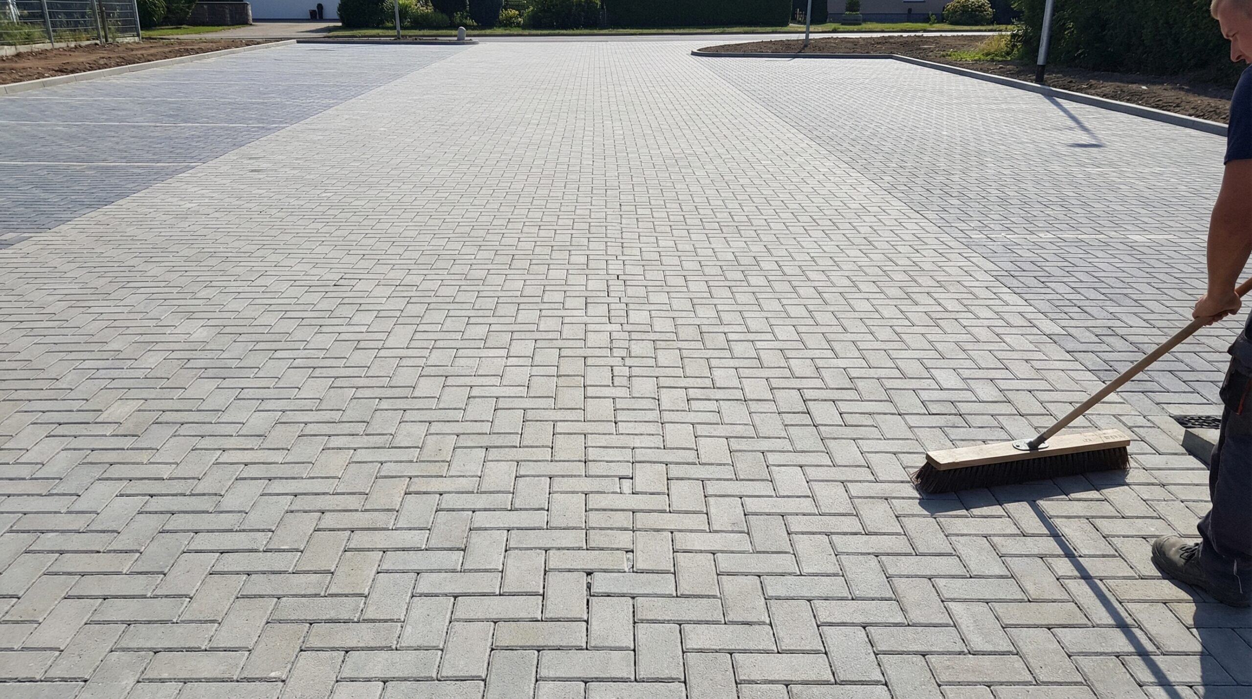 Step-by-step polymeric sand installation parking area