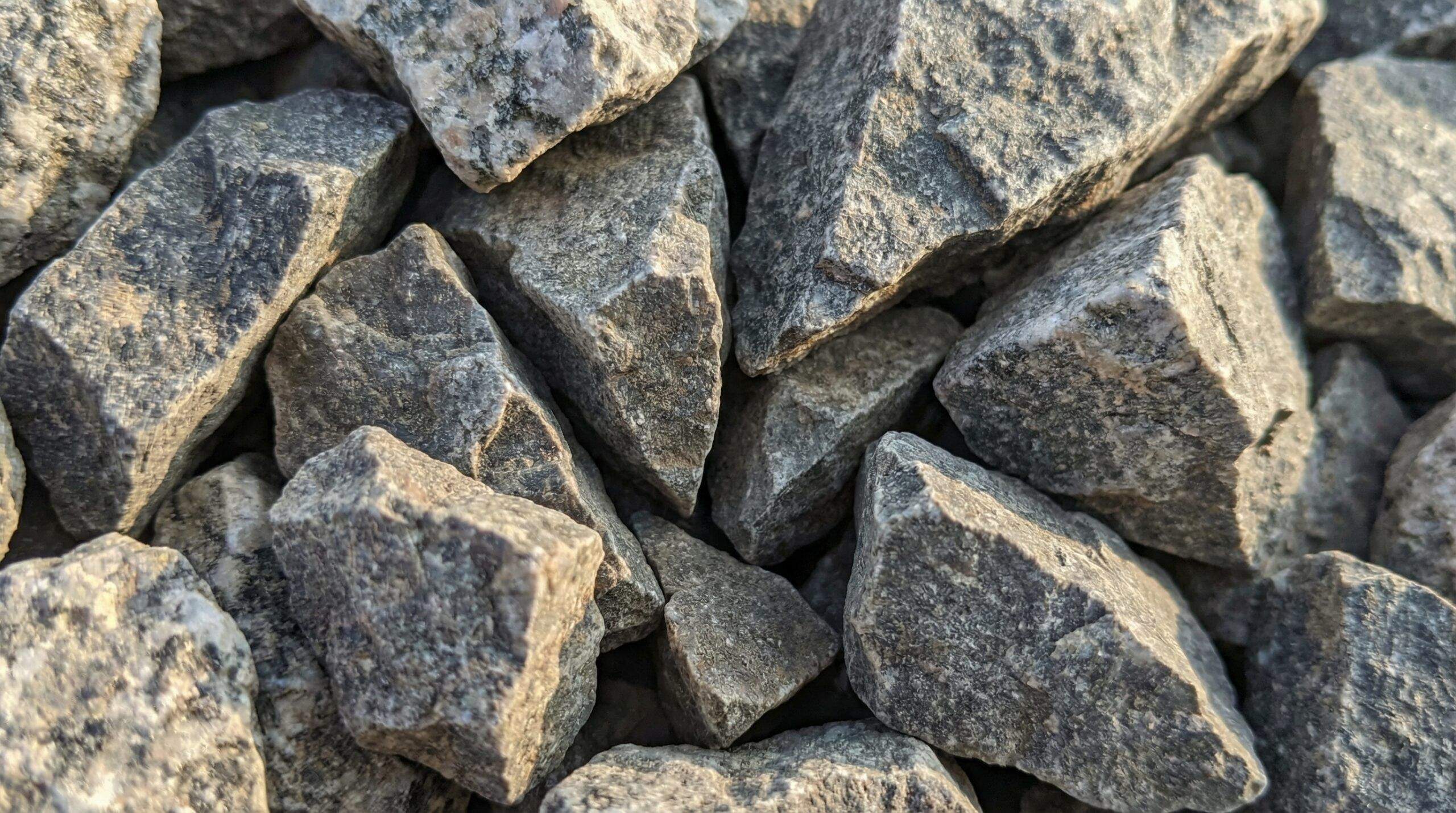 Close-up of angular crushed stone particles showing interlocking edges