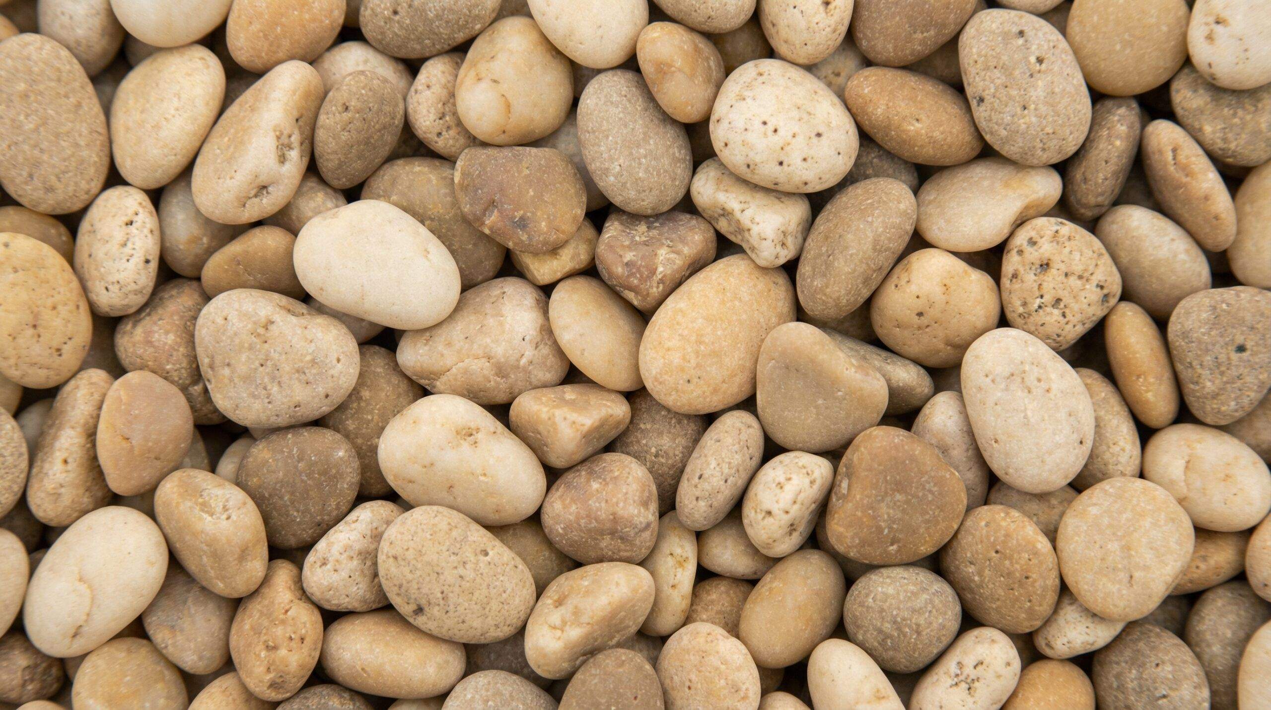 Close-up sand colored pea gravel texture